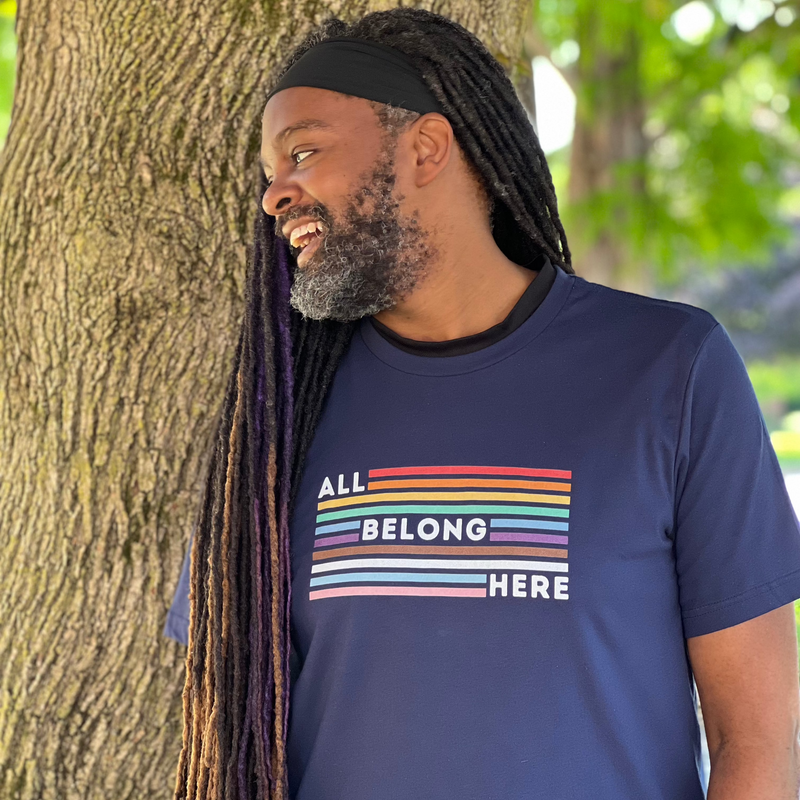 Darren rocking an All Belong Here t-shirt in rainbow colors